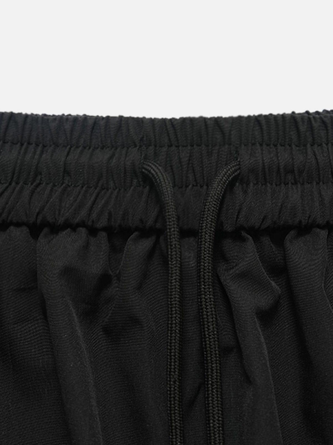 Elastic waistband detail of TALISHKO black shorts, showcasing comfortable summer style.