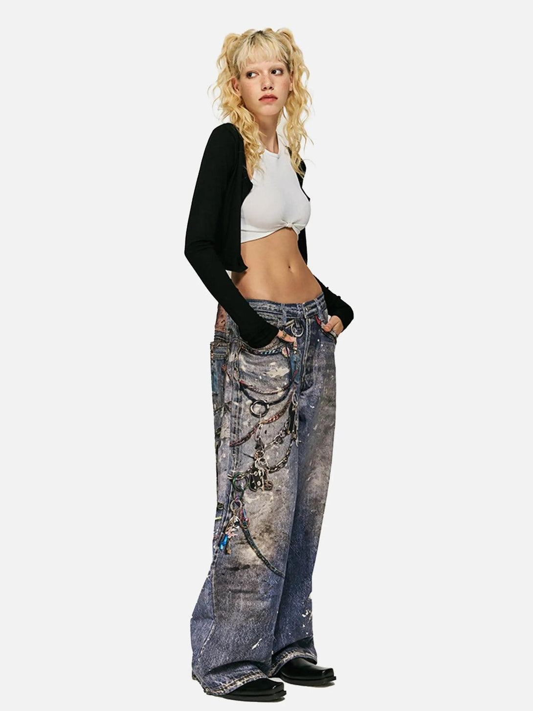 Model styled in TALISHKO's digital printed chain jeans, paired with a white crop top and black cardigan.