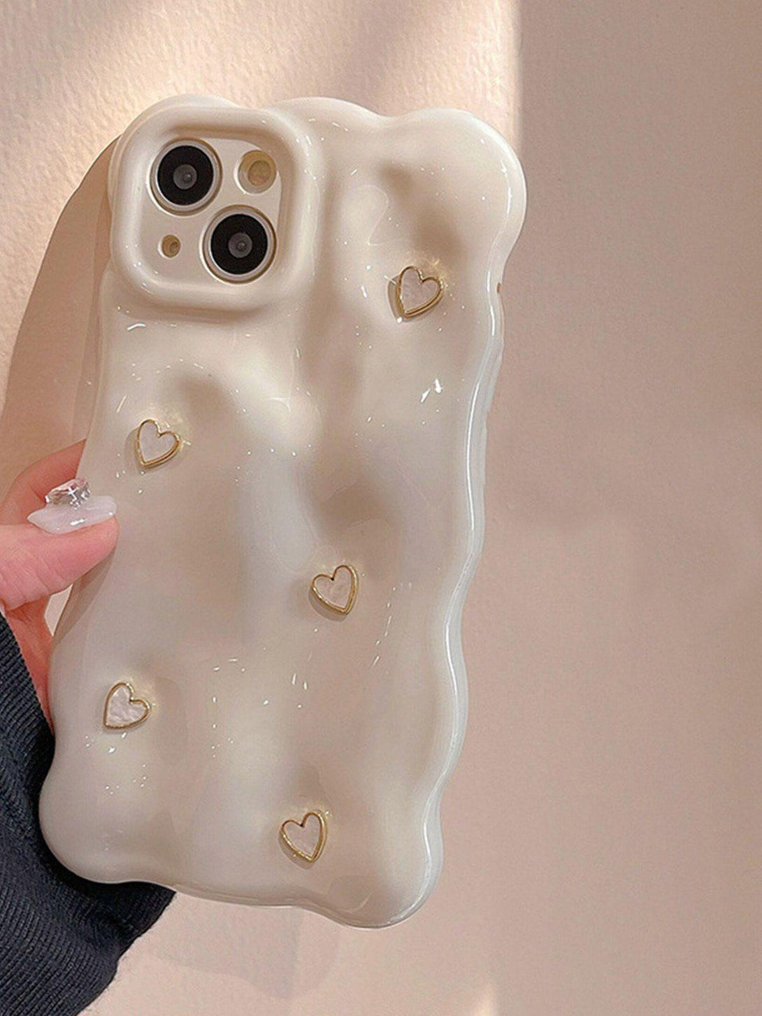 TALISHKO 3D Heart Phone Case with a glossy finish and delicate heart details, held in hand.