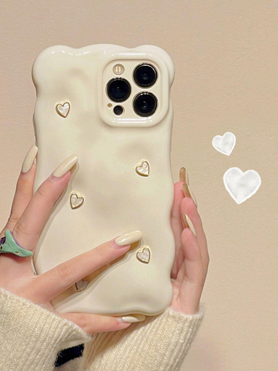 TALISHKO 3D Heart Phone Case in creamy white, held in hand, featuring cute heart embellishments.