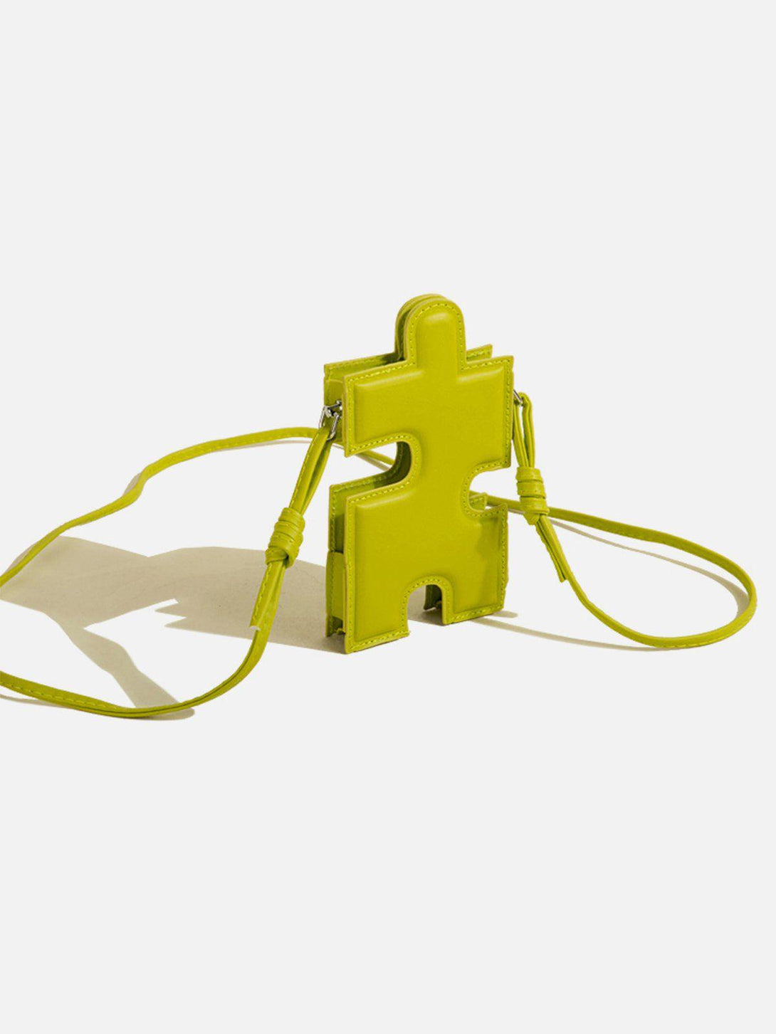 Vivid green 3D jigsaw puzzle bag with long strap by TALISHKO, ideal for playful styling.