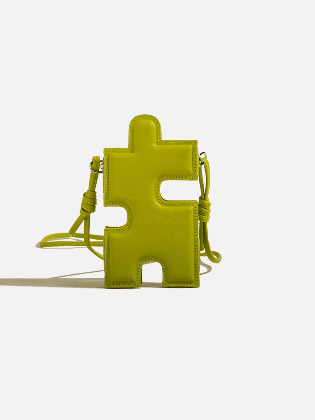 Unique 3D jigsaw puzzle-shaped bag in vibrant green by TALISHKO, featuring a playful design.
