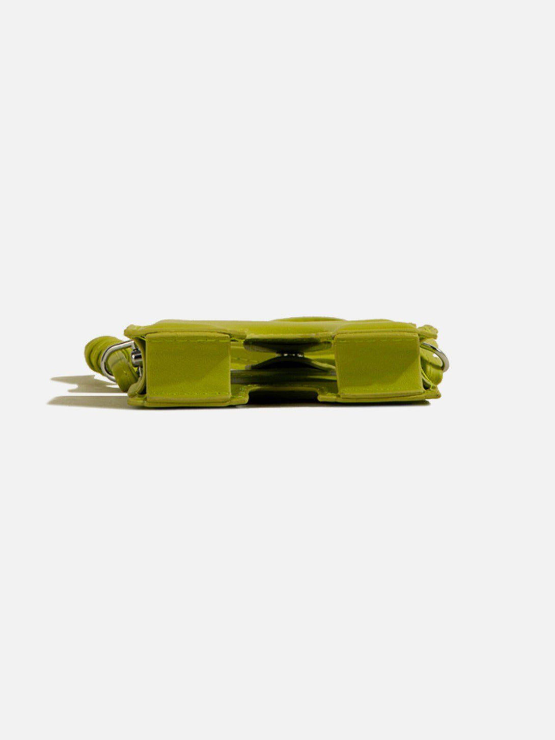 A side view of a vibrant green 3D jigsaw puzzle-shaped bag by TALISHKO, showcasing its unique design.
