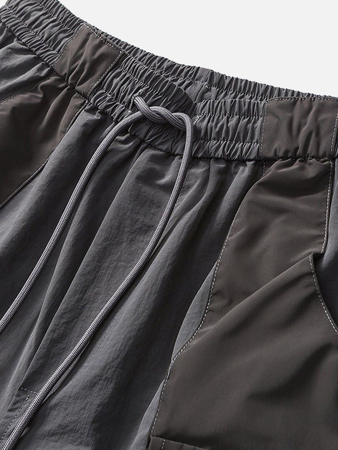 Intricate look at TALISHKO's drawstring shorts, highlighting textured fabric and 3D pocket design.