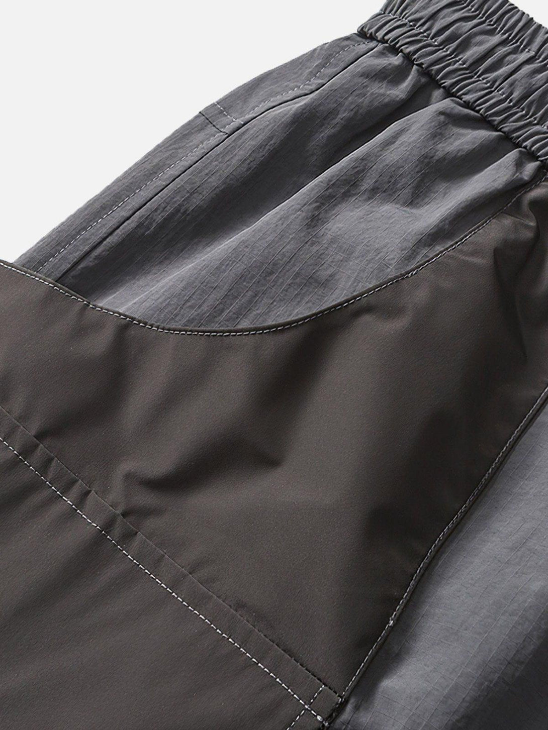 Detailed fabric and stitching on TALISHKO's 3D pocket drawstring shorts, showcasing texture.