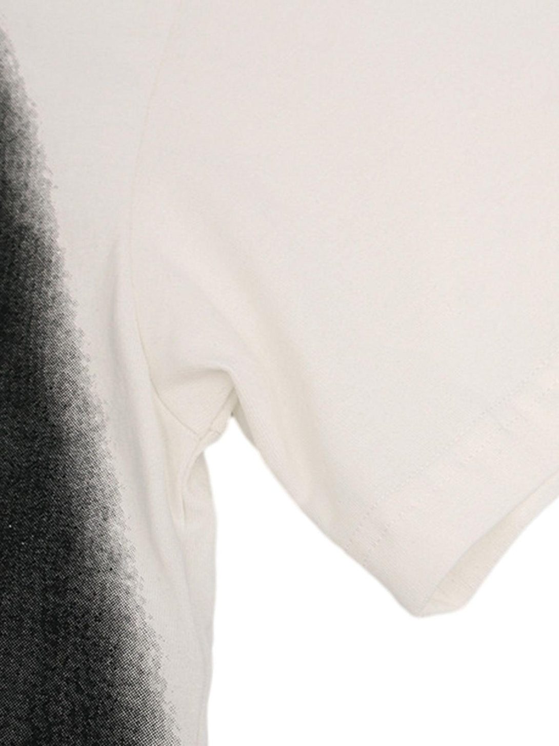 Detailed sleeve view of TALISHKO's abstract "KISS" graphic T-shirt, highlighting fabric texture.