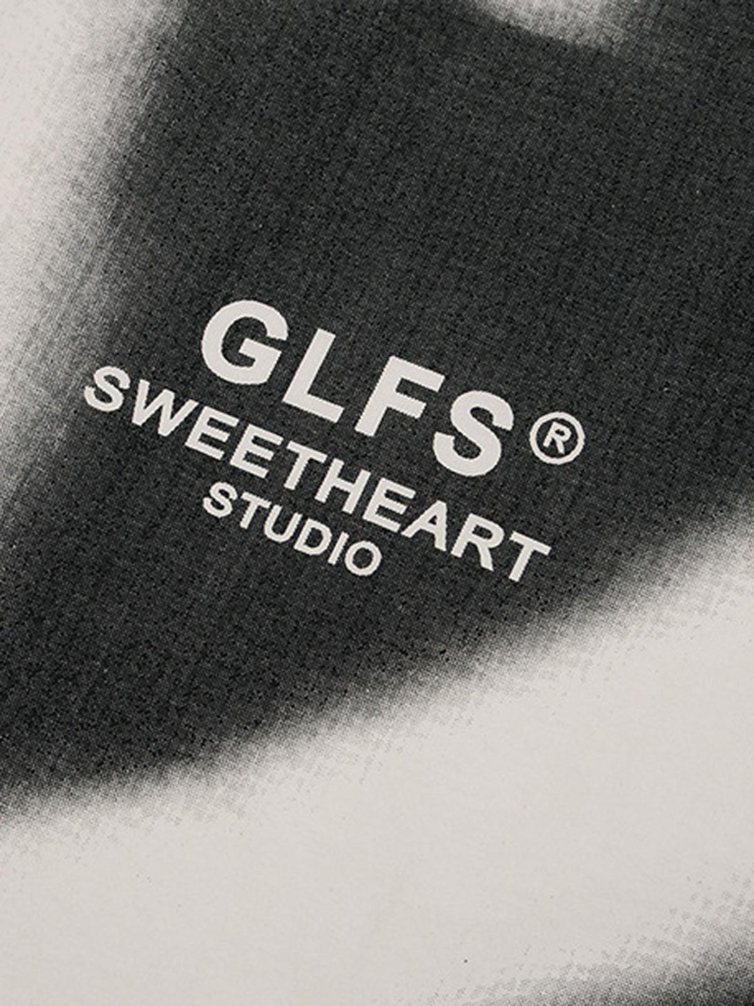 TALISHKO T-shirt showcasing an abstract "KISS" graphic, focusing on texture and monochrome design.