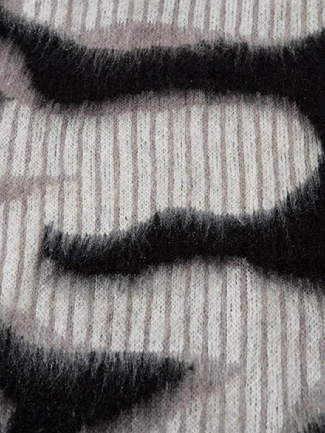 A detailed view of TALISHKO's mohair crew neck sweater, highlighting its abstract pattern and texture.