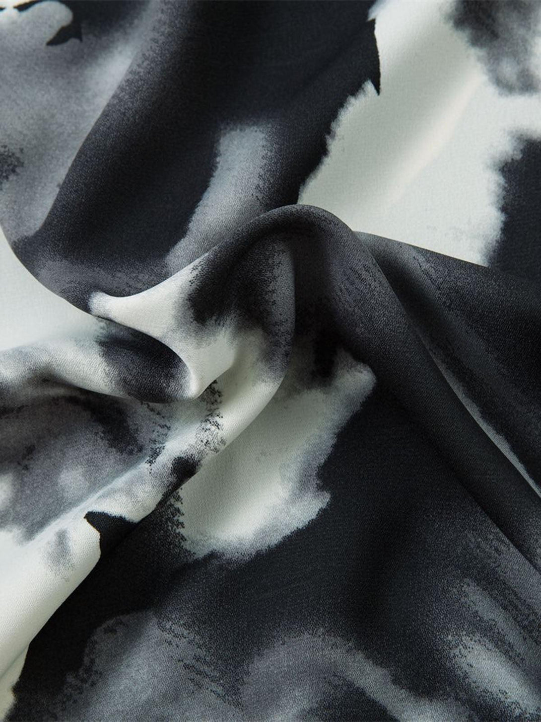 Zoomed-in texture of TALISHKO's abstract tie-dye print, highlighting the intricate monochrome pattern.