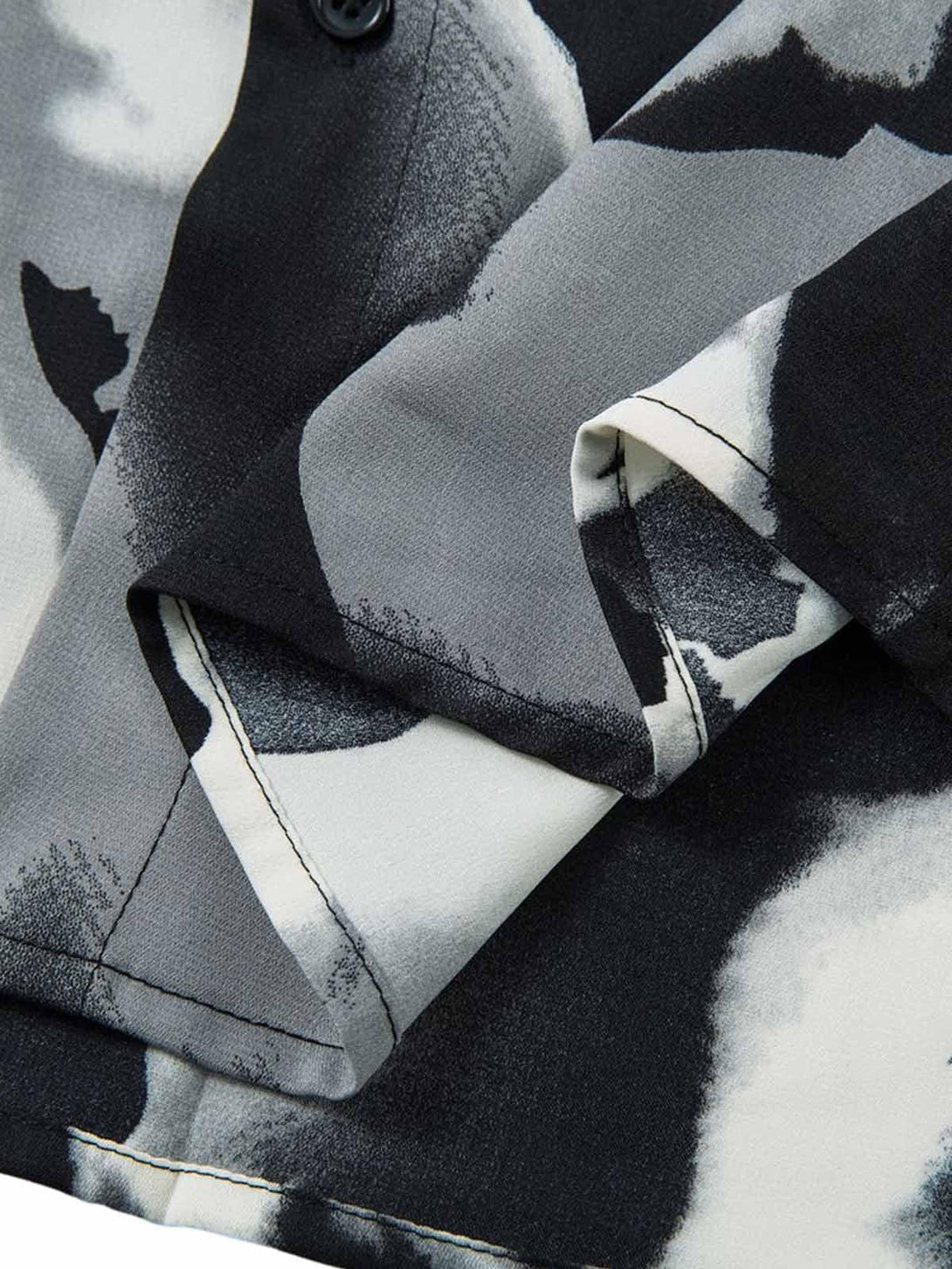 Intricate look at TALISHKO's abstract tie-dye shirt, focusing on the monochrome fabric detail.