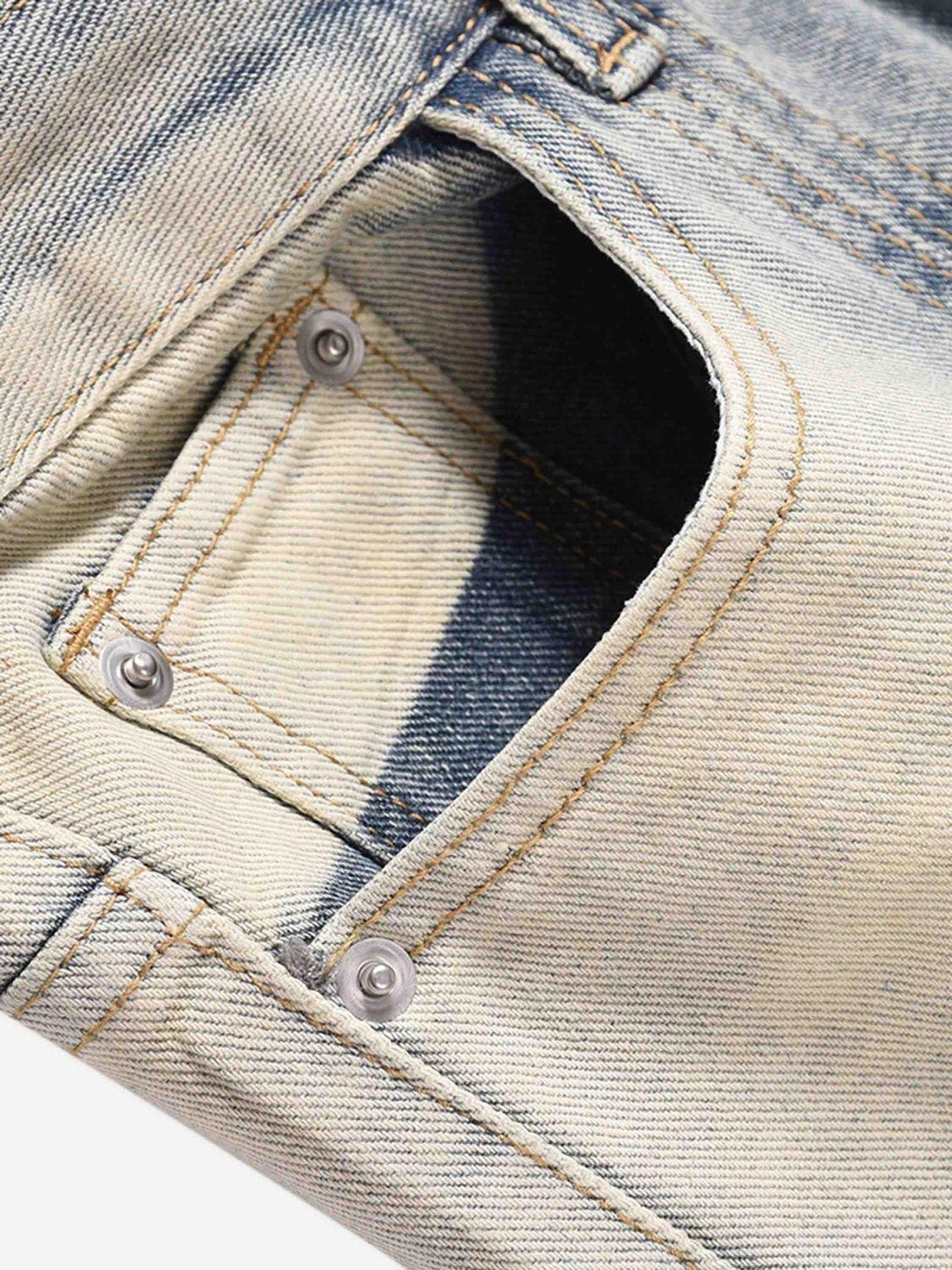 Intricate look at TALISHKO acid wash baggy jeans, showcasing rivet and stitching details.