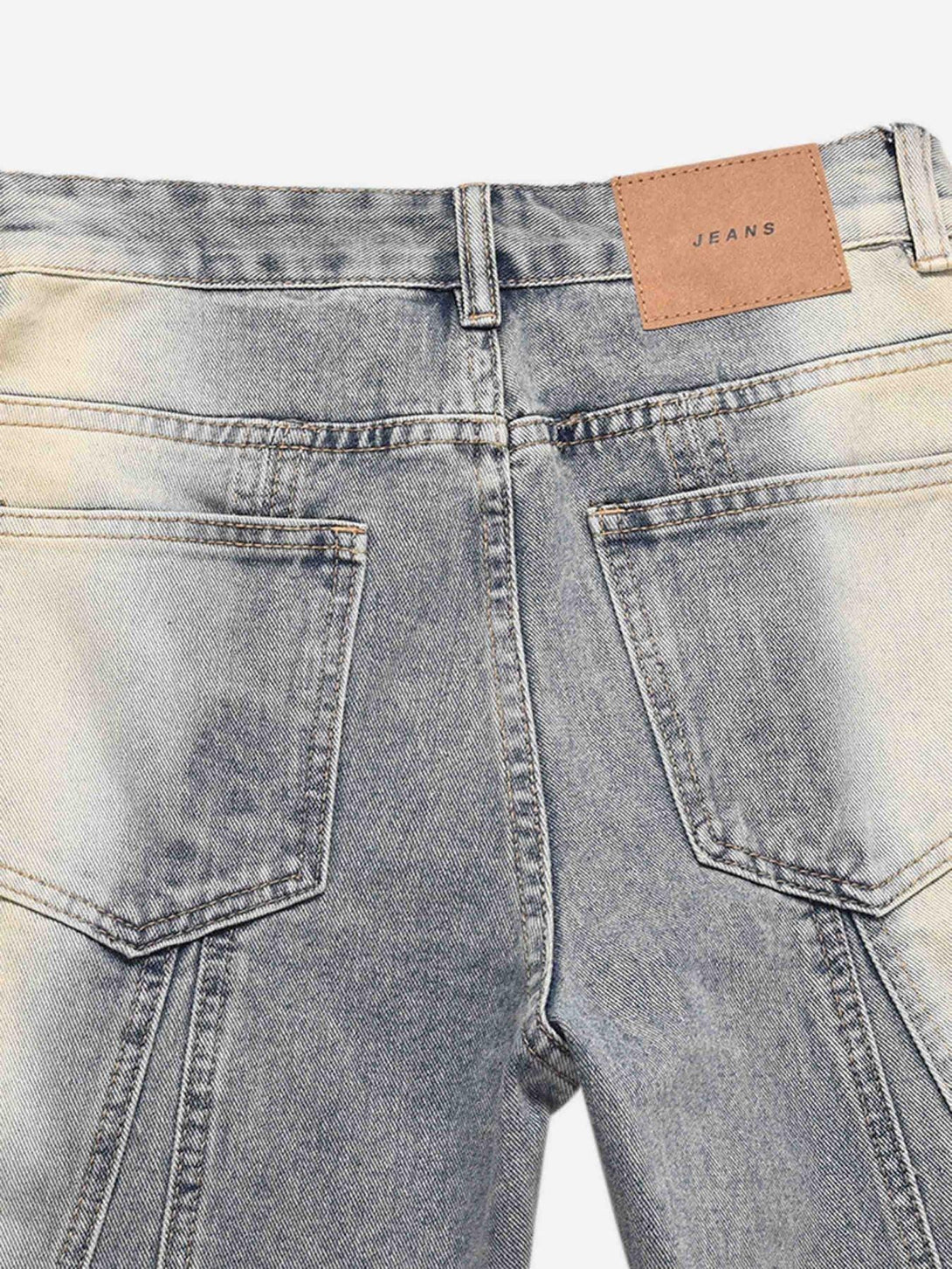 Detailed view of TALISHKO acid wash spray baggy jeans, focusing on back pocket design.