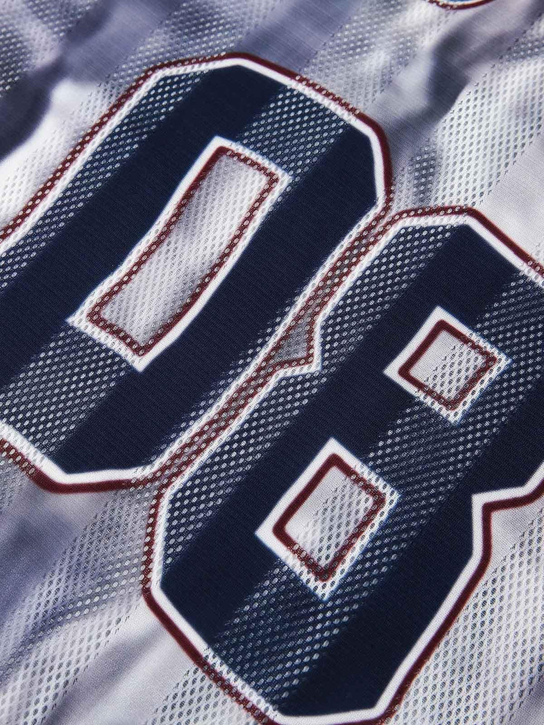 Close-up of TALISHKO jersey T-shirt highlighting the bold number design and mesh texture.