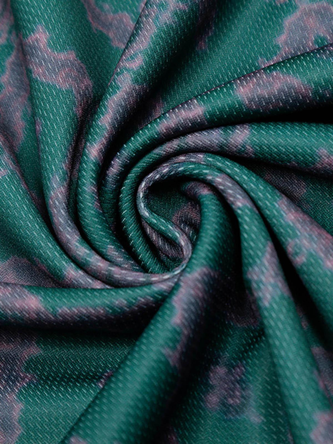 Texture and pattern showcased on the green jersey fabric by TALISHKO, highlighting unique details.