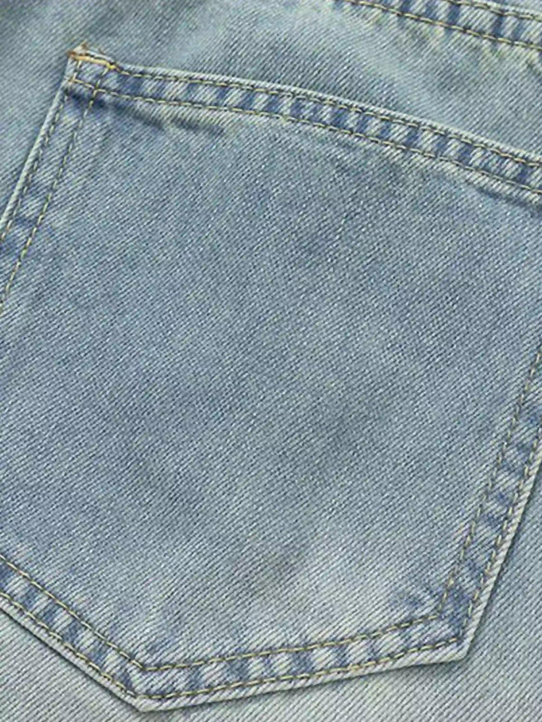 Focusing on the denim texture and stitching detail by TALISHKO, highlighting vintage charm.