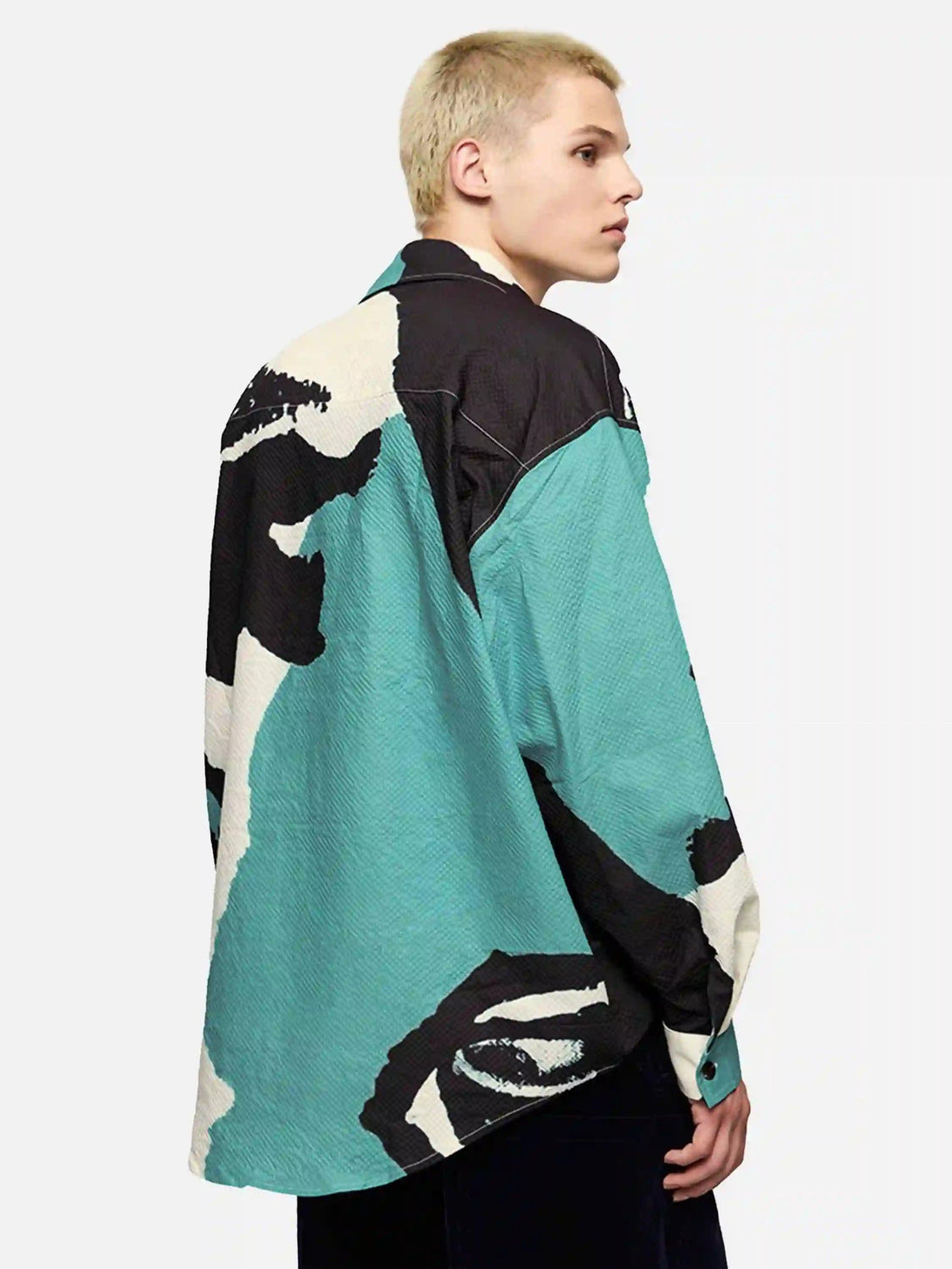 Model in TALISHKO's abstract portrait shirt, featuring a unique seersucker texture and design.