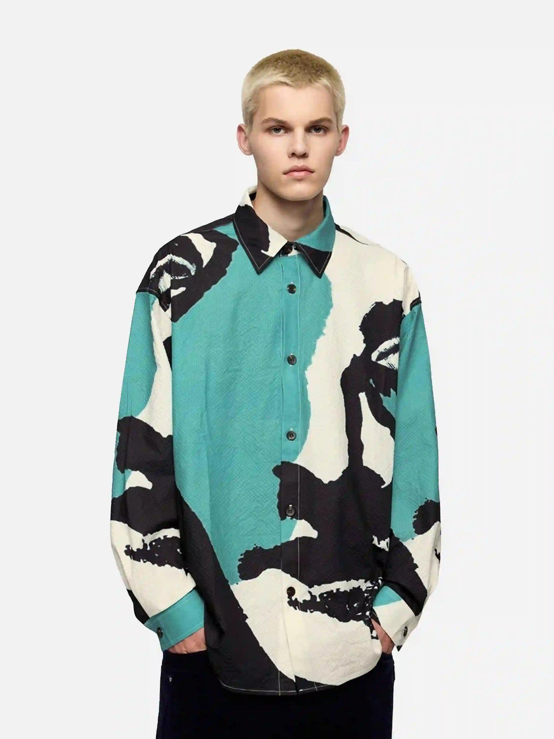 Model in TALISHKO's seersucker shirt with abstract portrait, blending art and fashion.