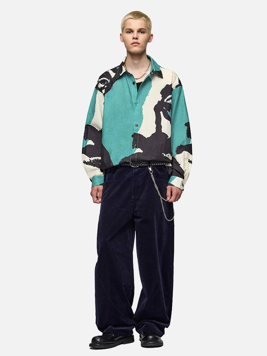 Model in TALISHKO's abstract shirt paired with loose navy trousers, creating a bold fashion statement.