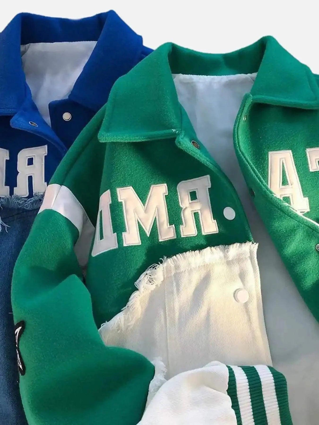 TALISHKO's green and blue baseball jackets feature bold lettering and stylish splicing details.