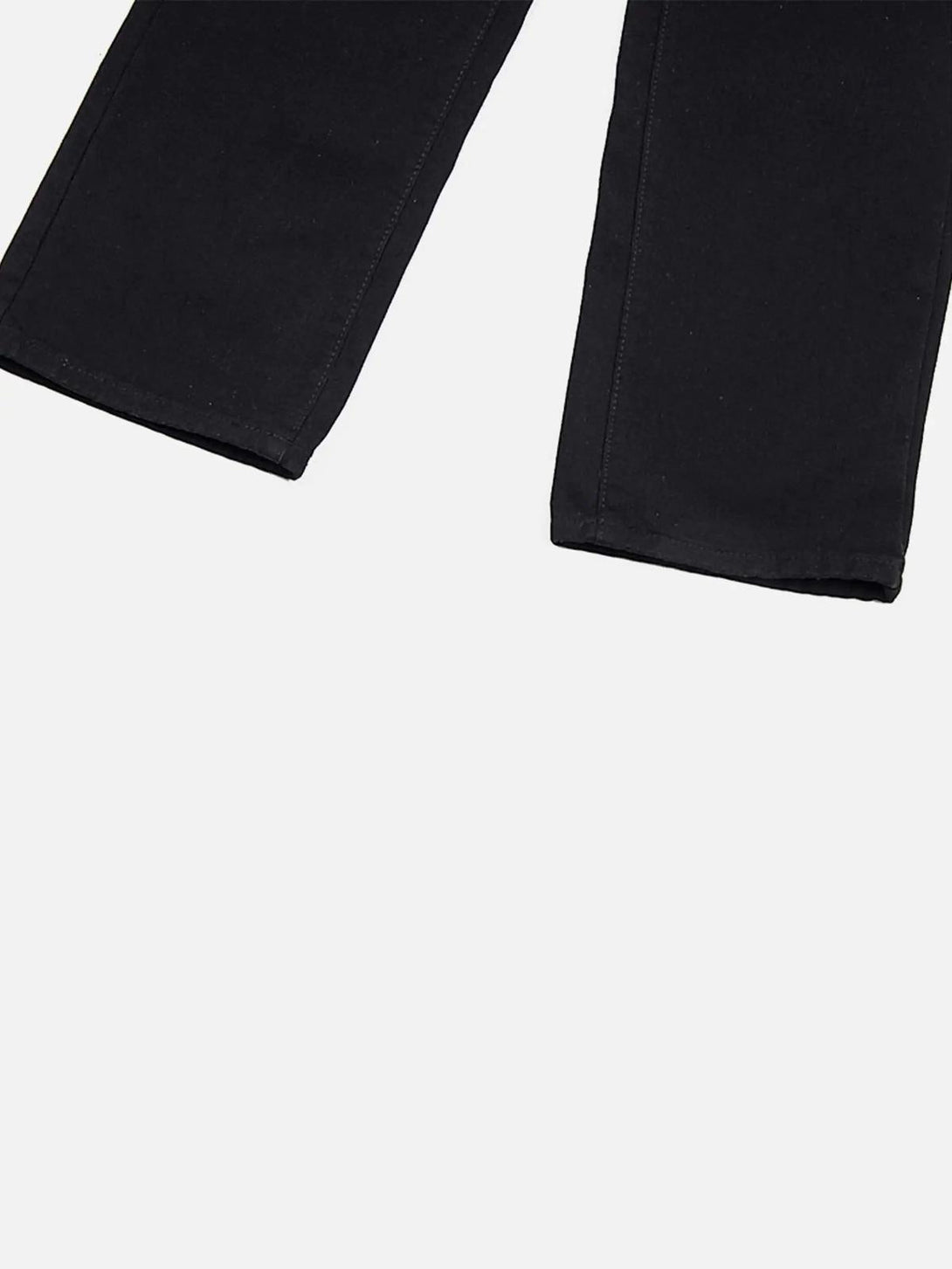 A close-up of TALISHKO black jeans' hems, showcasing sleek design and classic stitching.