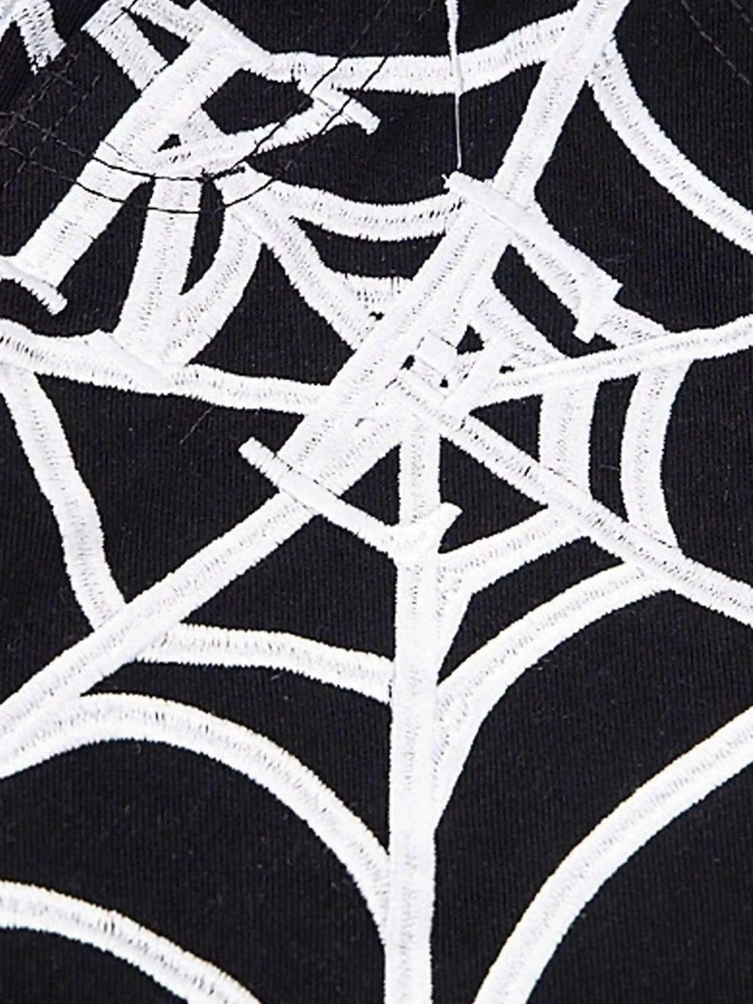 Spider web embroidery detail on TALISHKO jeans, highlighting intricate design and texture.