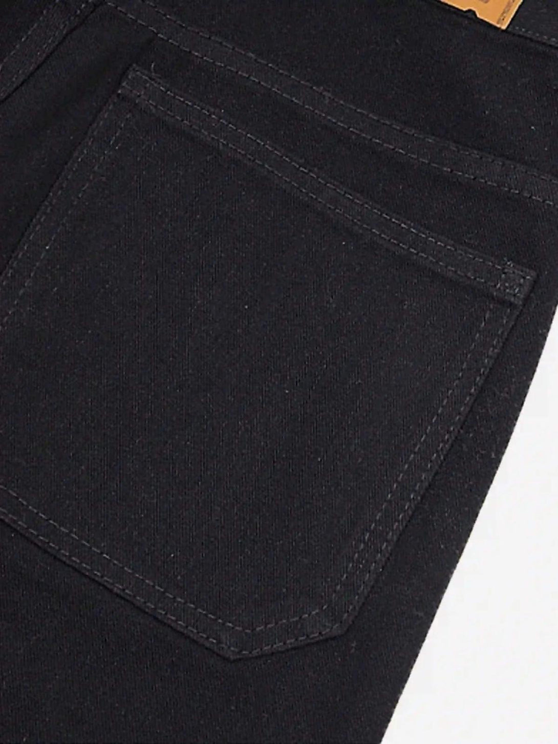 Detailed view of TALISHKO black jeans pocket, showcasing classic stitching and sleek design.