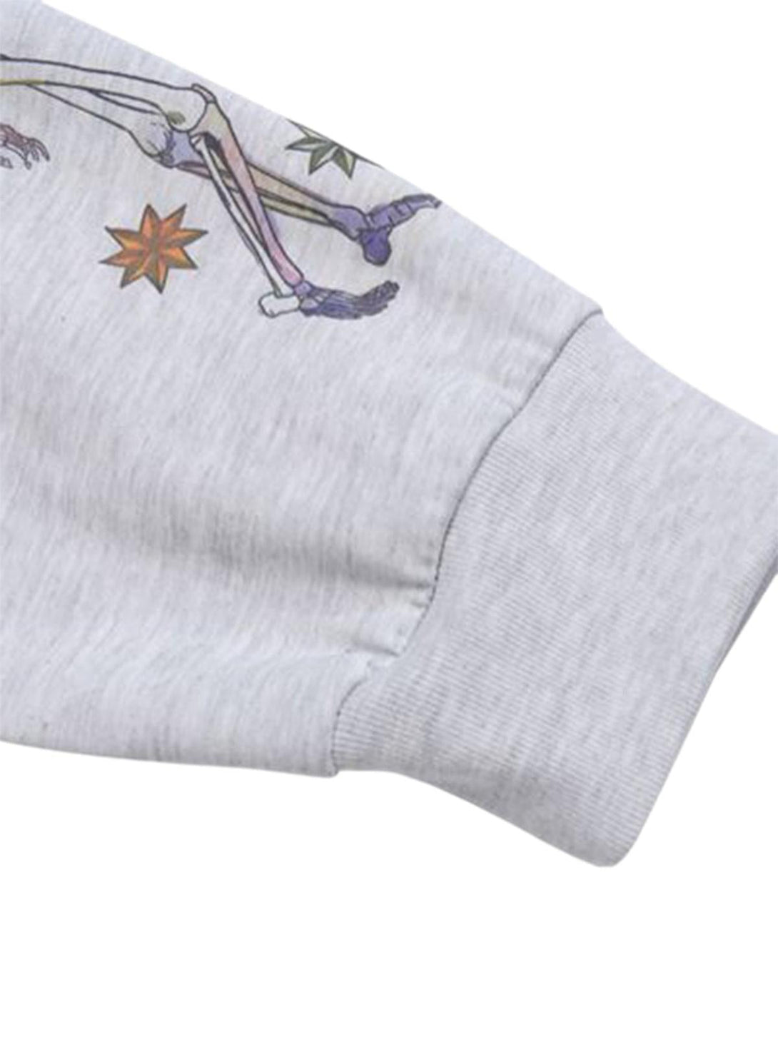 A detailed look at the sleeve of a TALISHKO T-shirt, featuring colorful graffiti-style graphics.