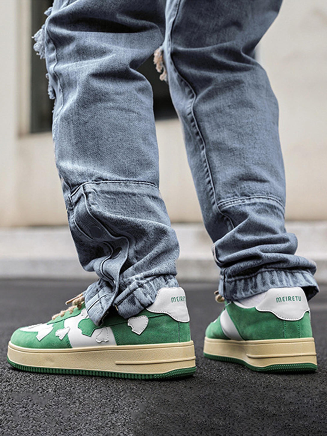 Casual green retro sneakers by TALISHKO, styled with distressed jeans for a street-ready look.