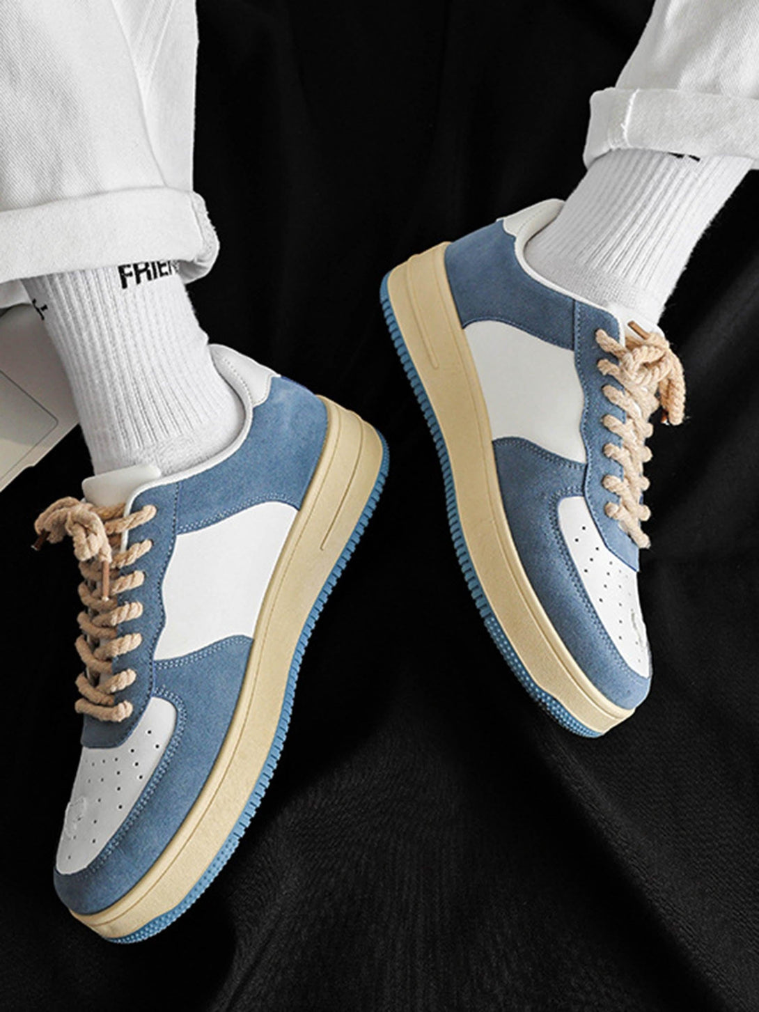 Casual retro sneakers by TALISHKO in blue and white, styled with rolled-up pants for a trendy look.