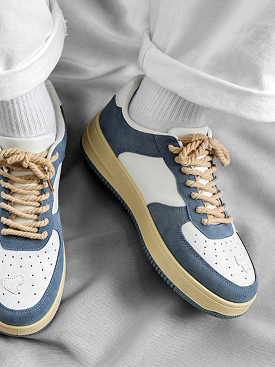 Retro casual shoes by TALISHKO in blue and white, paired with rolled-up white pants.