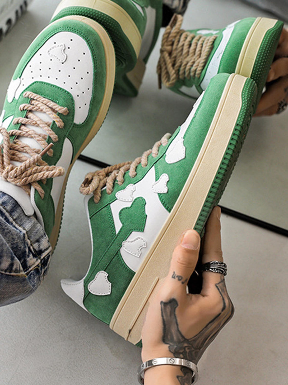 TALISHKO green and white casual shoes with cloud patterns and rope laces, detailed close-up.
