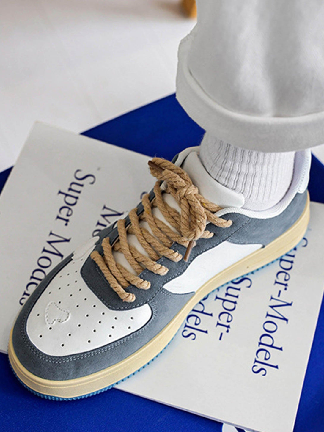 Casual retro shoes by TALISHKO with rope laces, styled with white socks for a chic look.