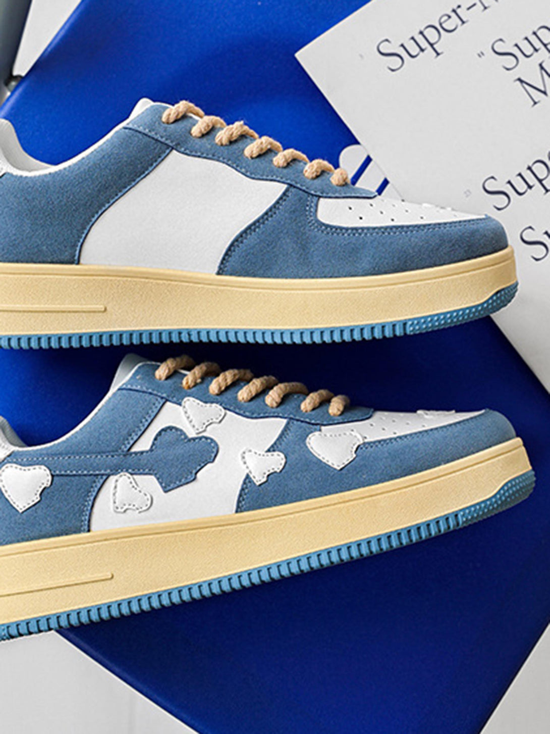 Stylish retro sneakers by TALISHKO, featuring blue and white cloud designs and rope laces.