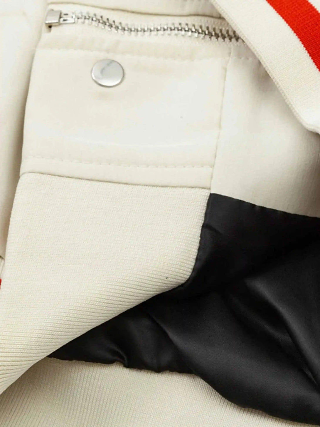 Detailed fabric and stitching on TALISHKO's baseball jacket, highlighting urban hip-hop style.