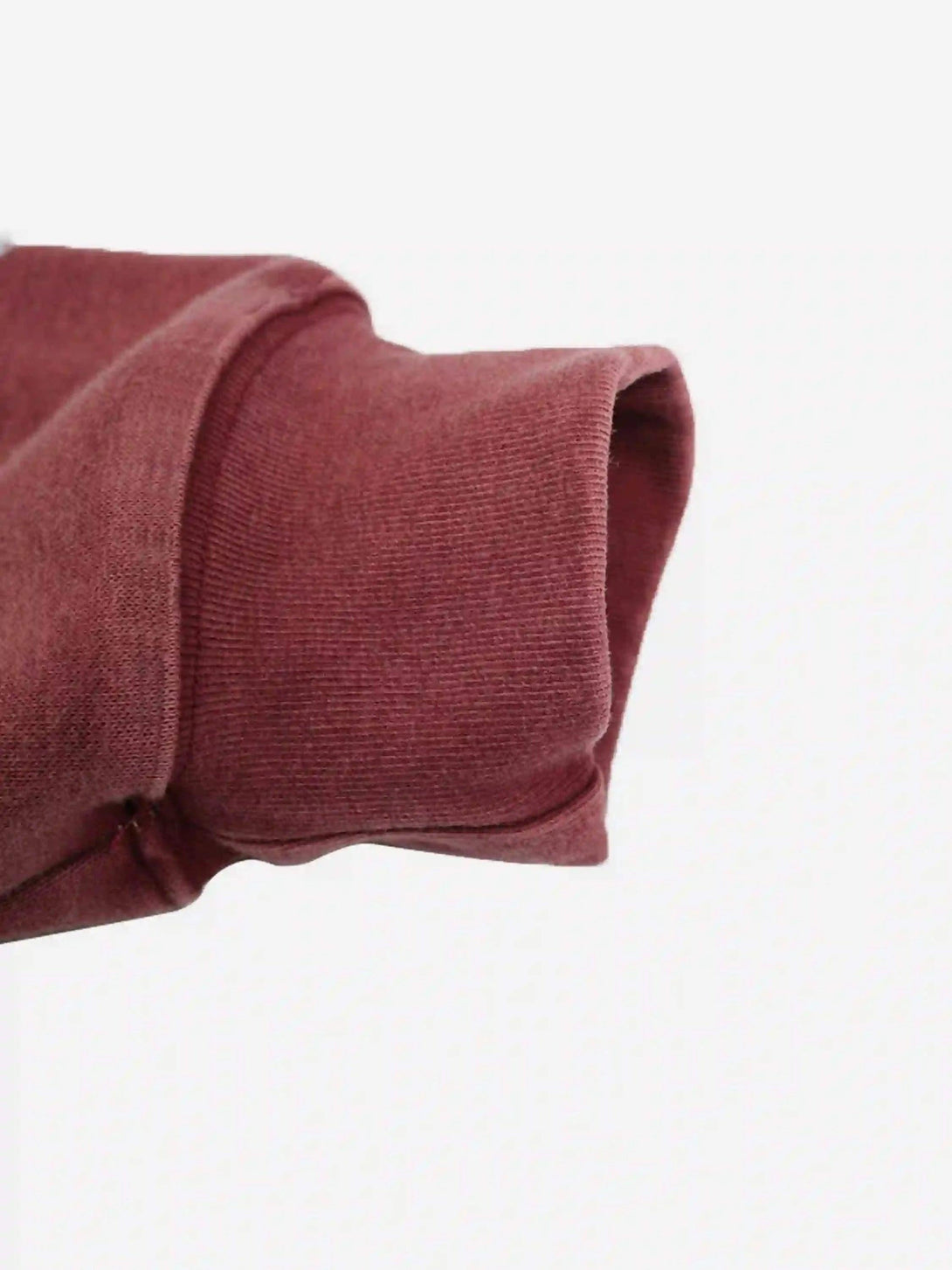 A detailed look at the cuff of a red TALISHKO hoodie, emphasizing its cozy ribbed texture.