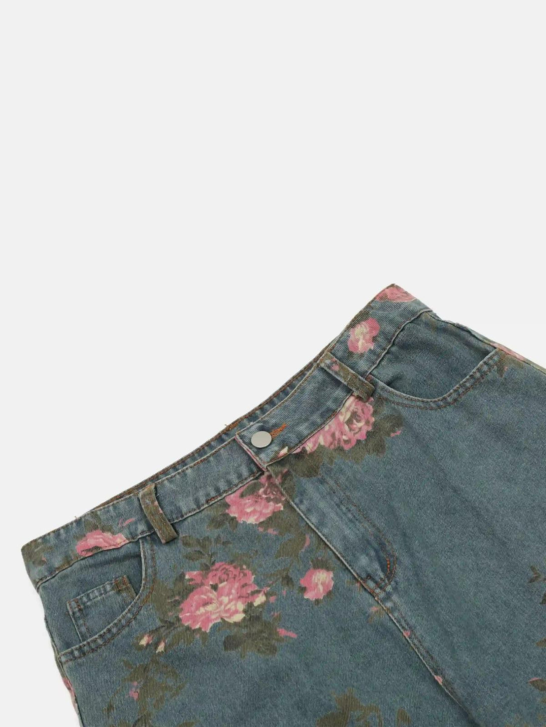 A detailed look at TALISHKO vintage rose-patterned jeans, highlighting their unique floral design.