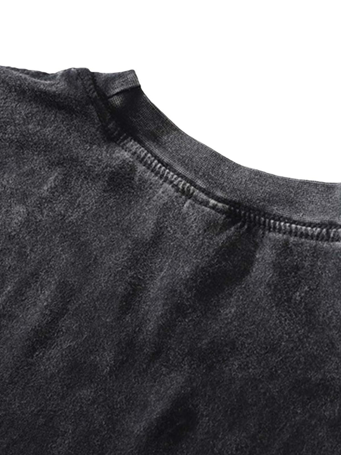 A close-up of the neckline on a black TALISHKO hip-hop T-shirt, highlighting fabric texture.