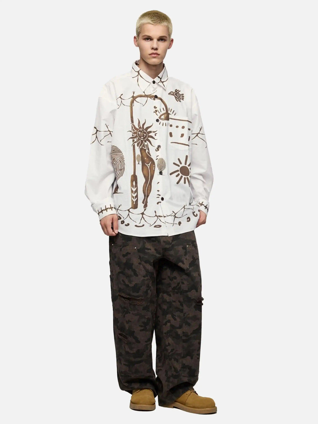 Model in a TALISHKO abstract mural shirt paired with camo pants, showcasing a bold style.