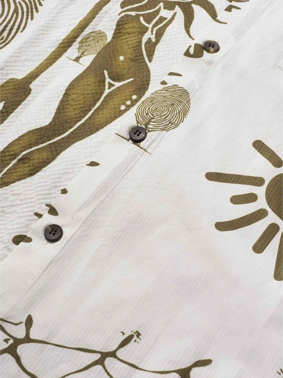 Detailed look at TALISHKO shirt's abstract design with earthy tones and button accents.
