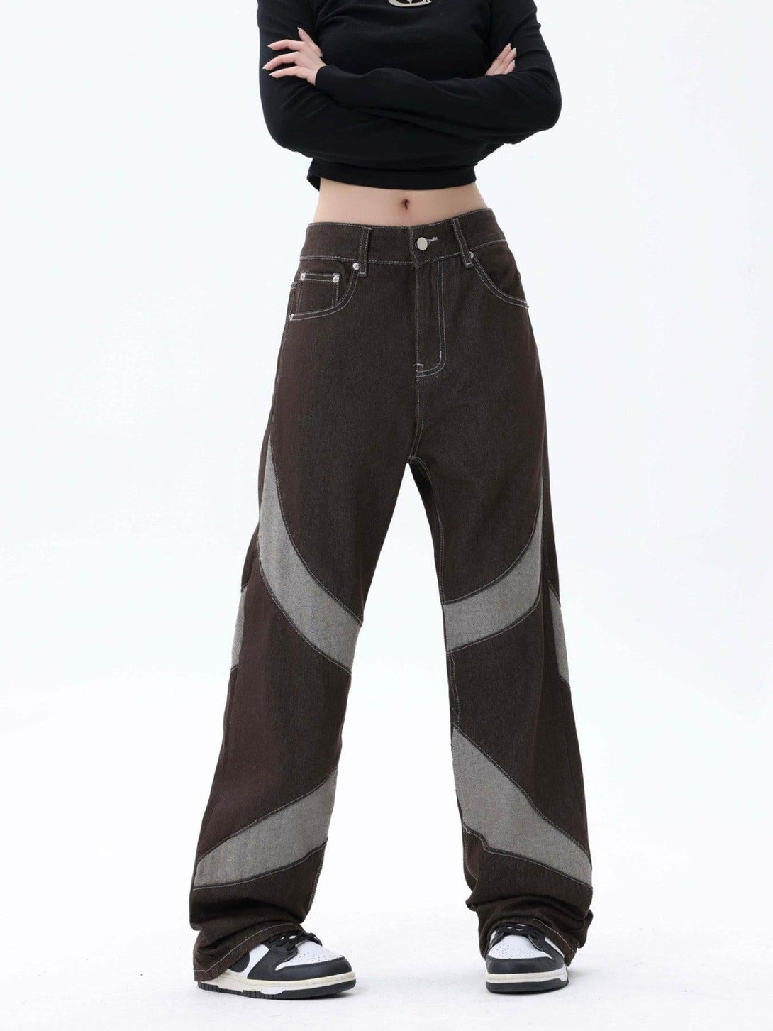 Model in TALISHKO patchwork jeans, featuring a stylish contrast pattern and relaxed fit.