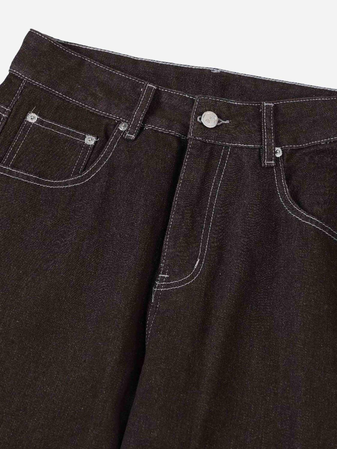 A detailed view of TALISHKO American patchwork jeans, highlighting contrasting stitching.