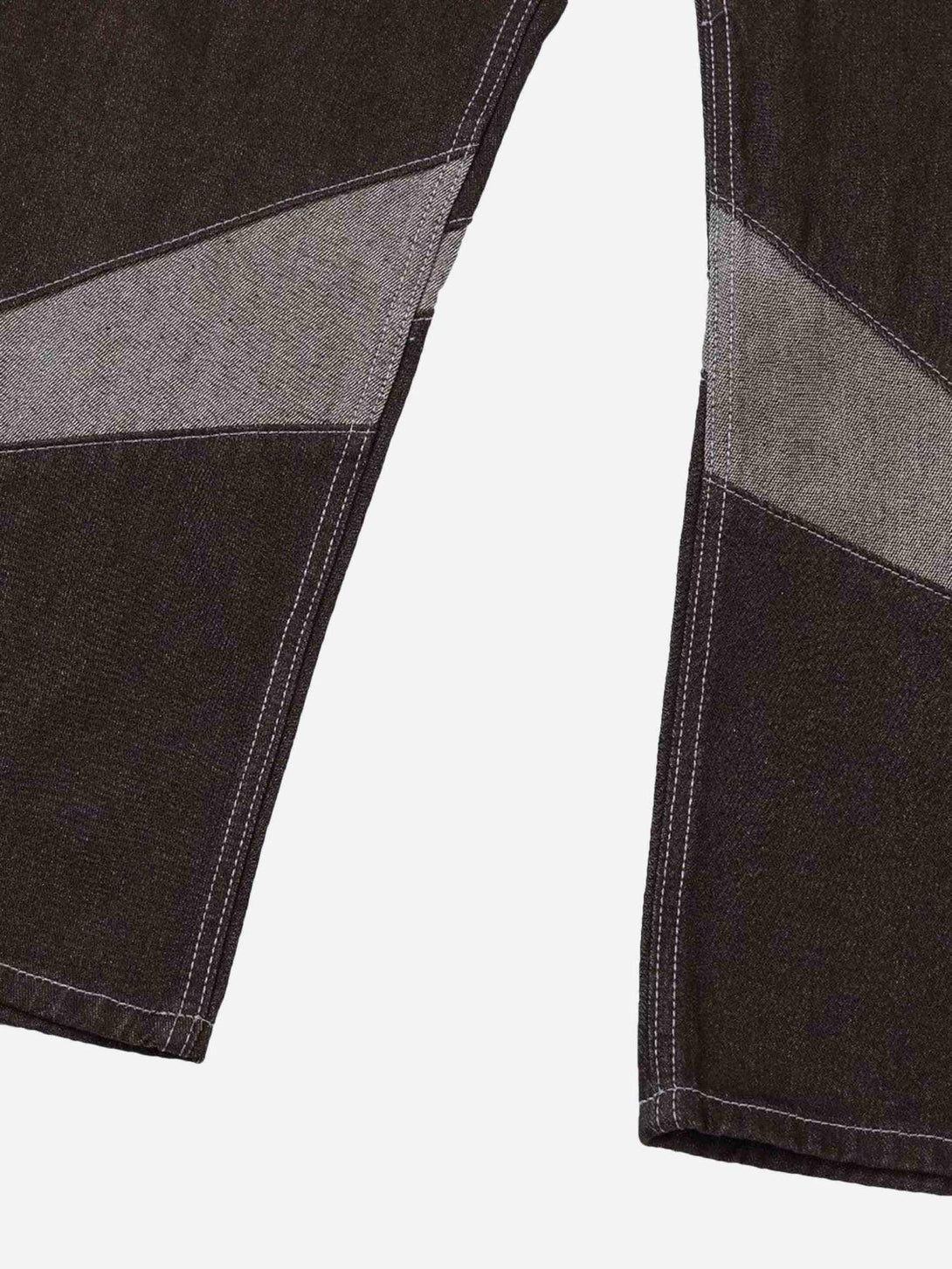 Detailed fabric and stitching of TALISHKO American patchwork jeans with contrasting patterns.