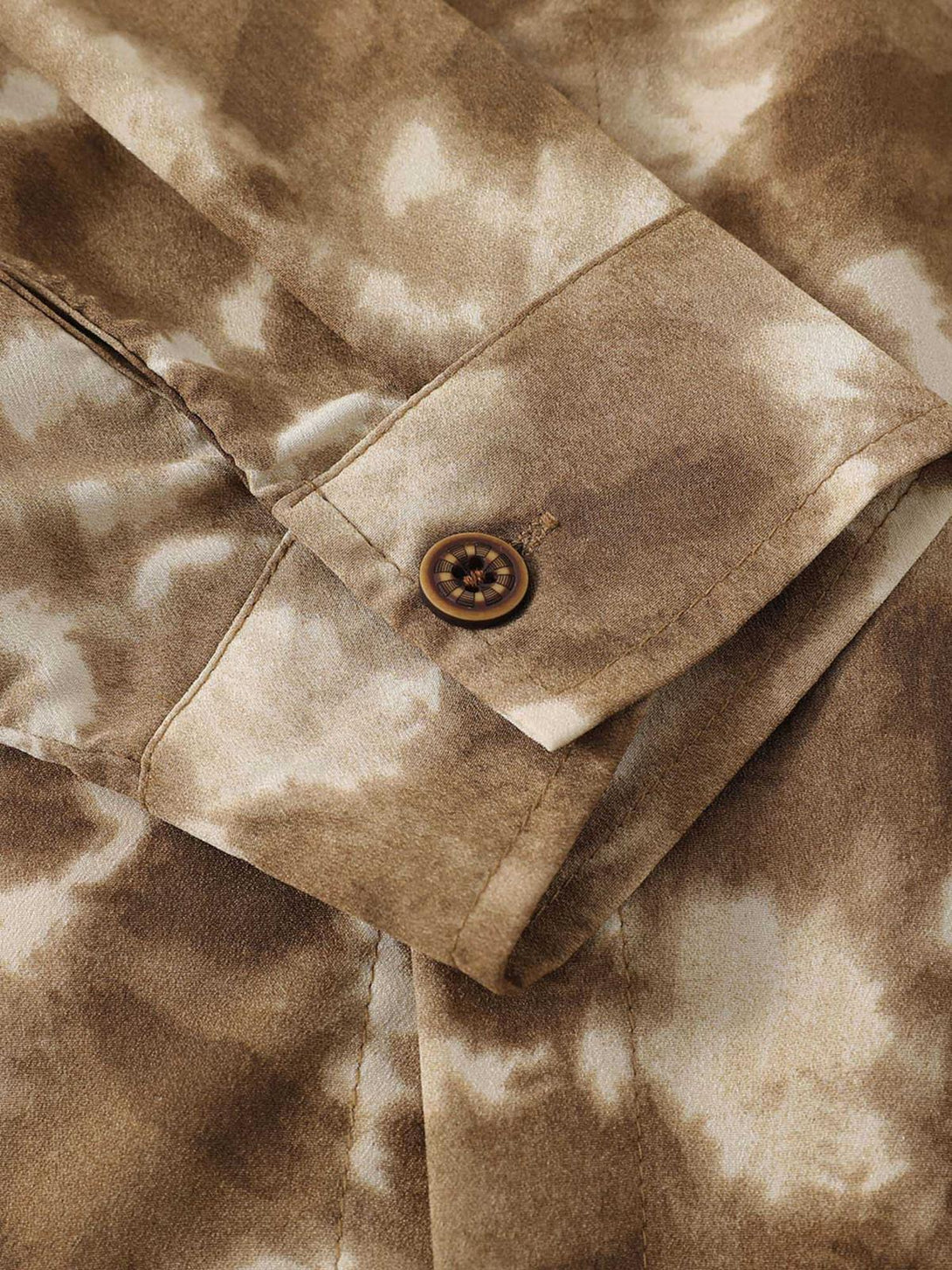 Zoomed-in texture of the TALISHKO shirt, highlighting its retro tie-dye design.