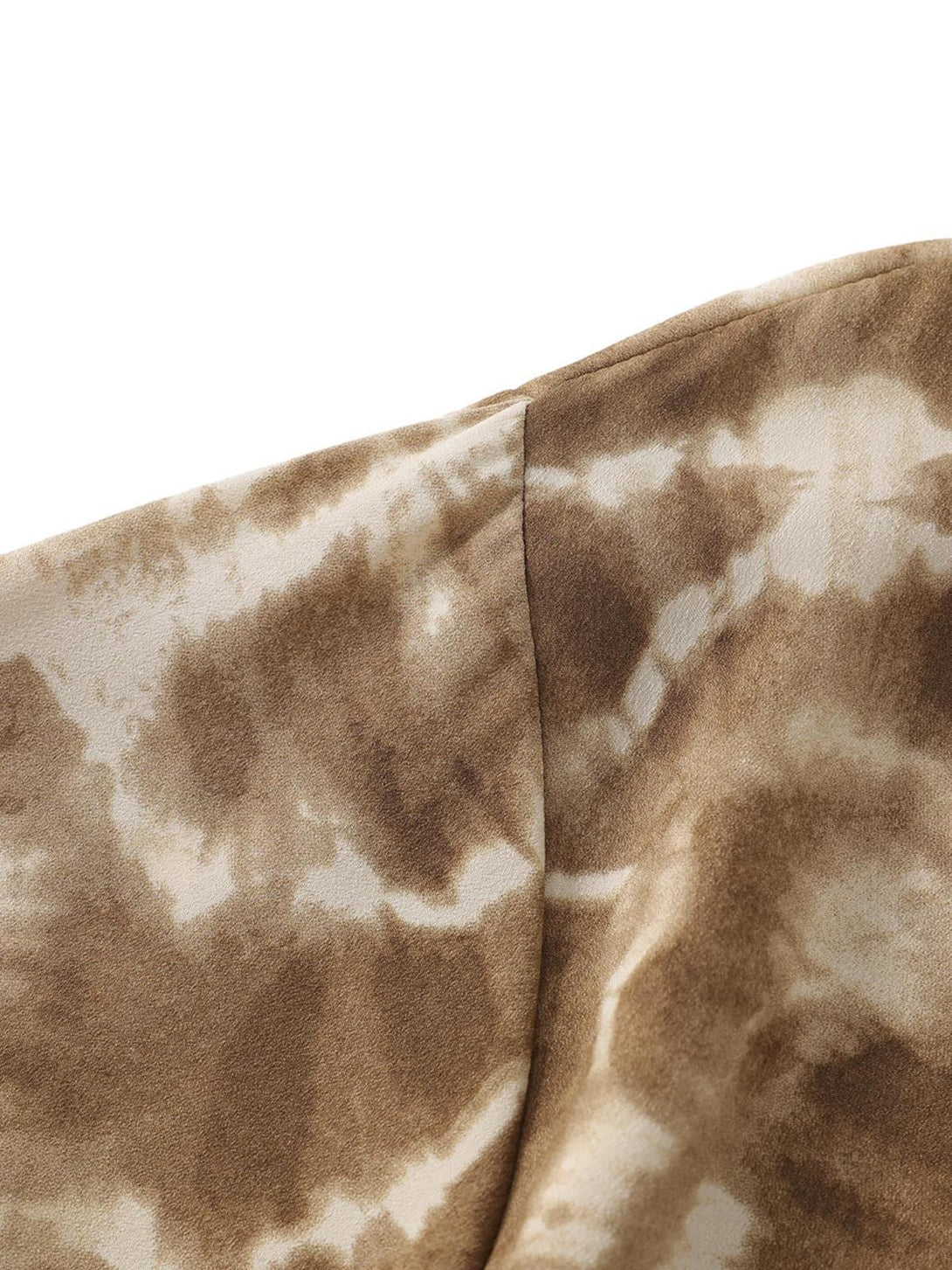 Focusing on the TALISHKO shirt's intricate tie-dye texture, offering a retro-inspired look.