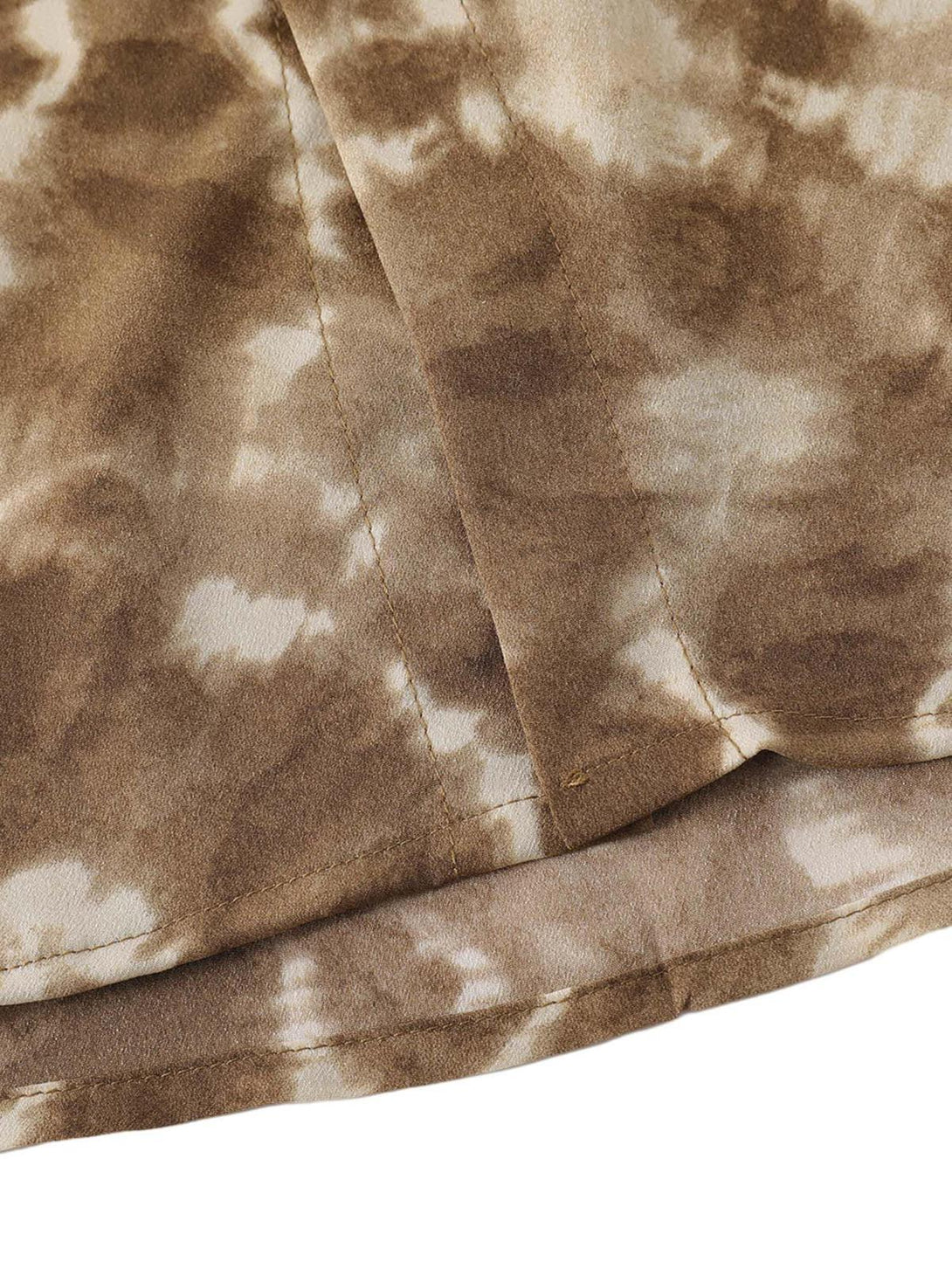 Intricate look at TALISHKO's retro tie-dye shirt fabric, showcasing its unique texture.
