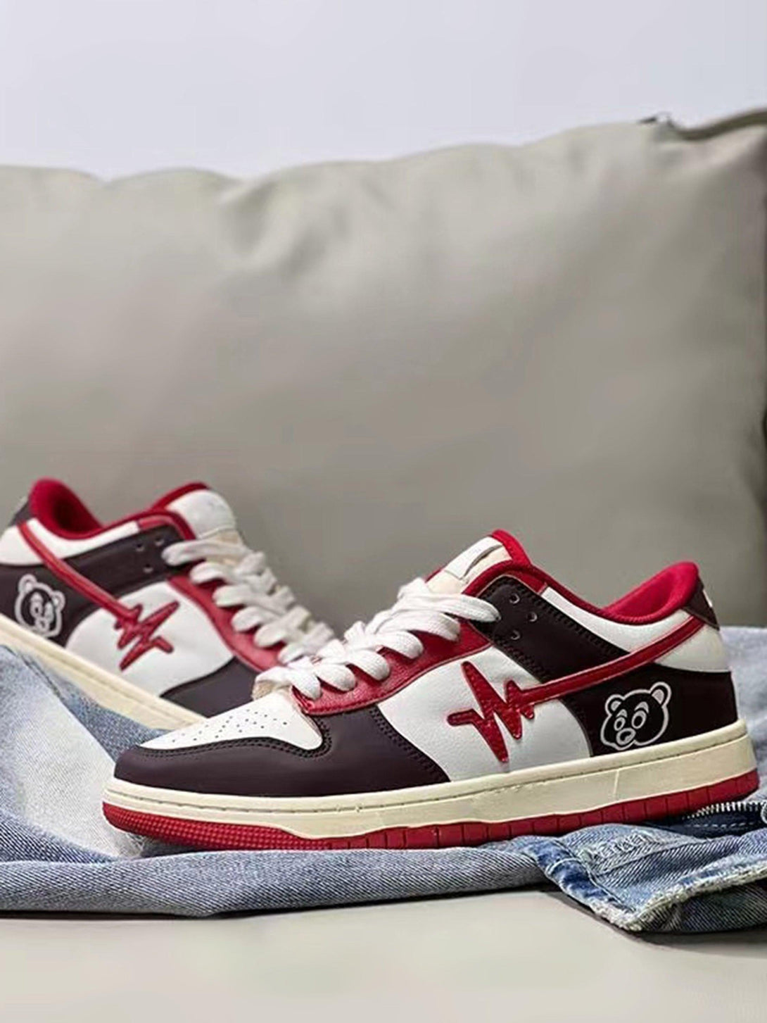 TALISHKO sneakers in a stylish colorway with graphic details, resting on denim fabric.