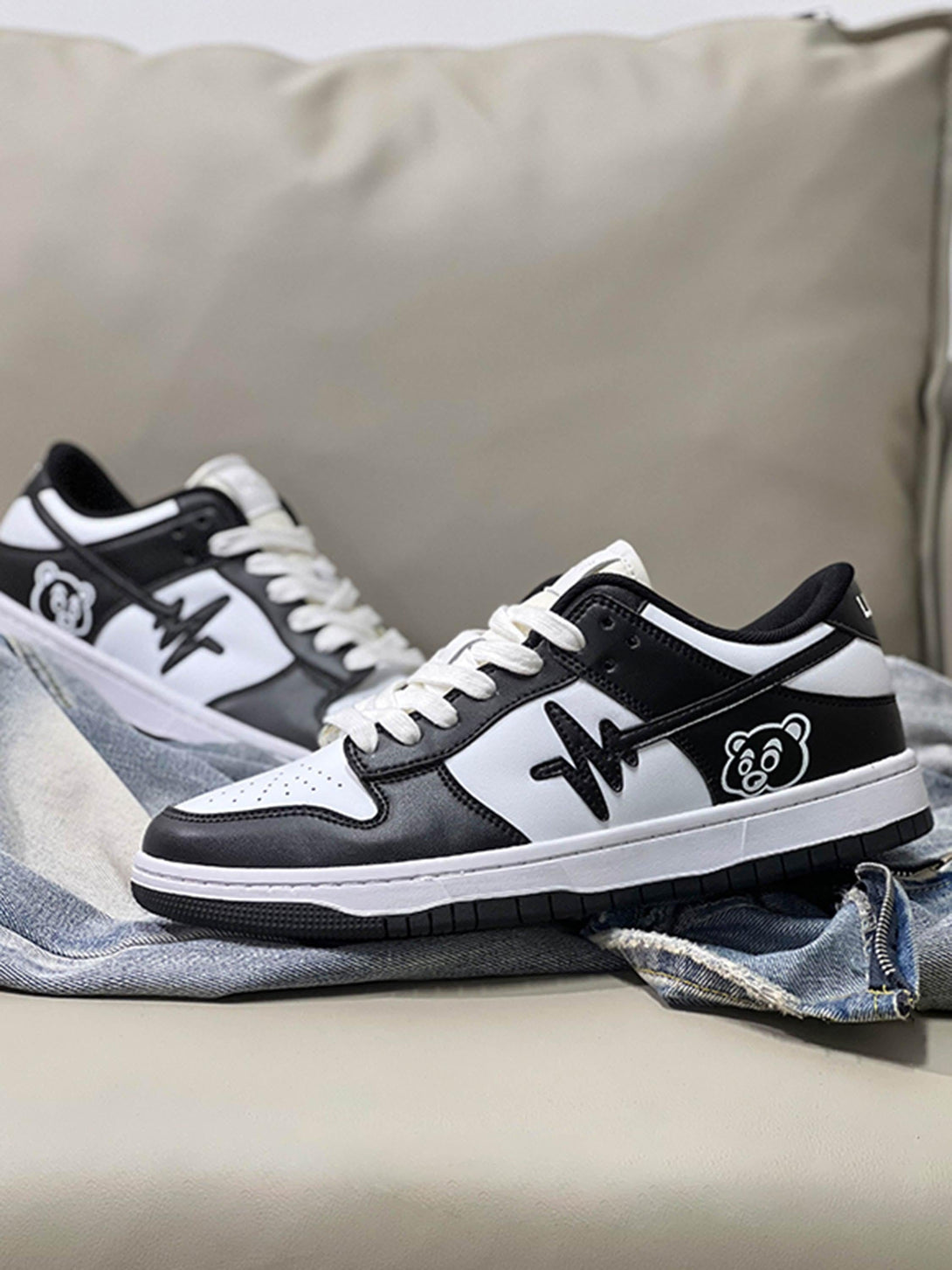 Side view of TALISHKO American retro sneakers in black and white with unique graphic accents.