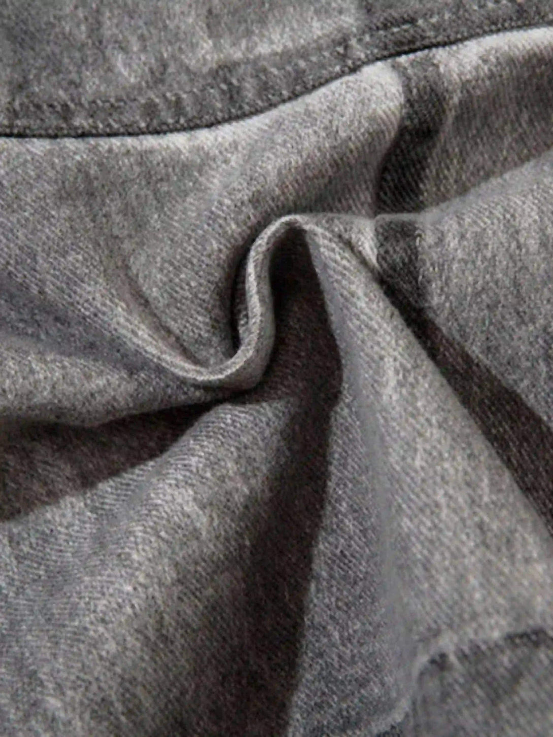 Texture and fabric detail of TALISHKO's distressed cargo shorts, showcasing rugged style.