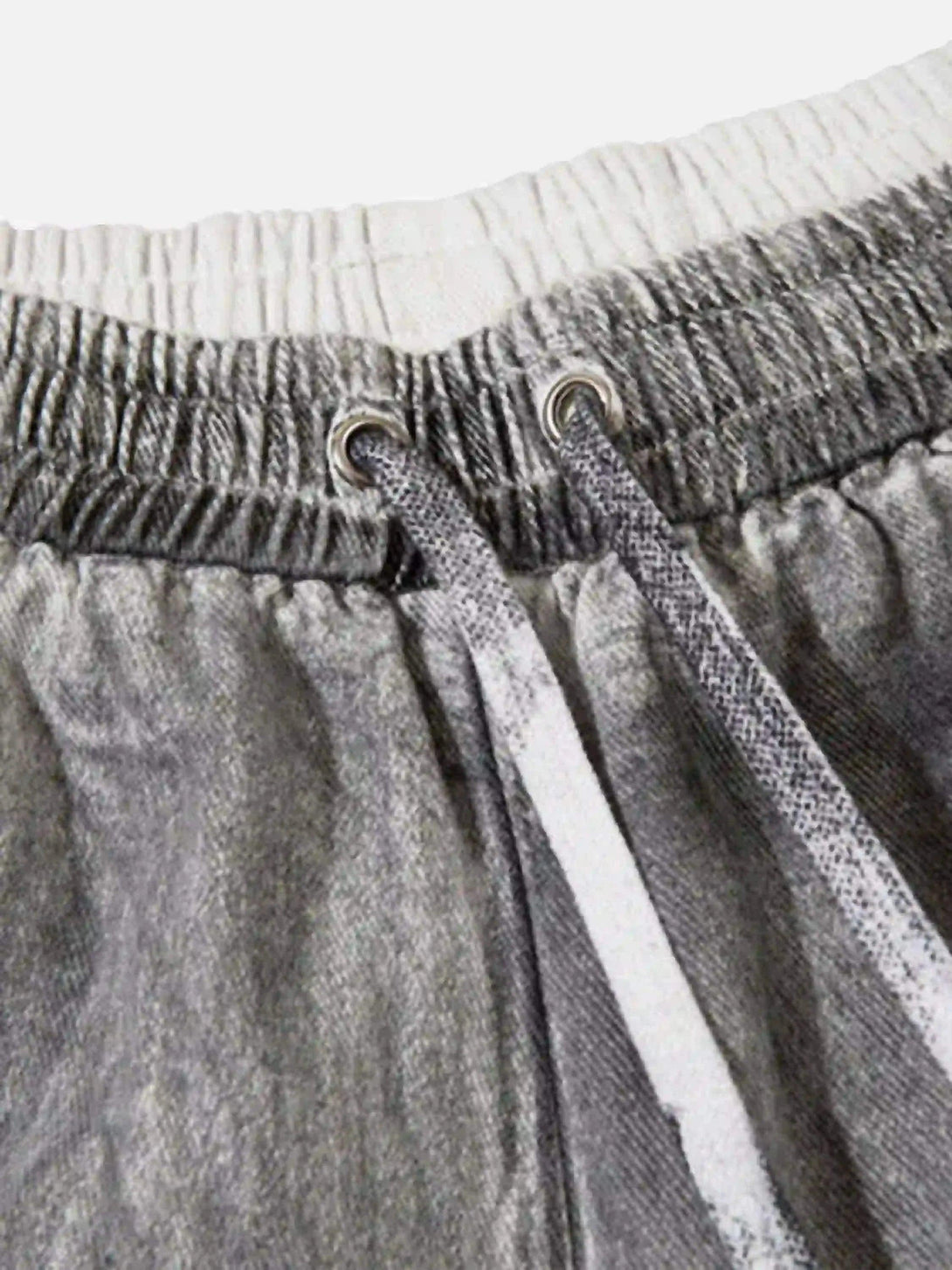 A detailed view of TALISHKO's cargo shorts, highlighting the drawstring and elastic waistband.