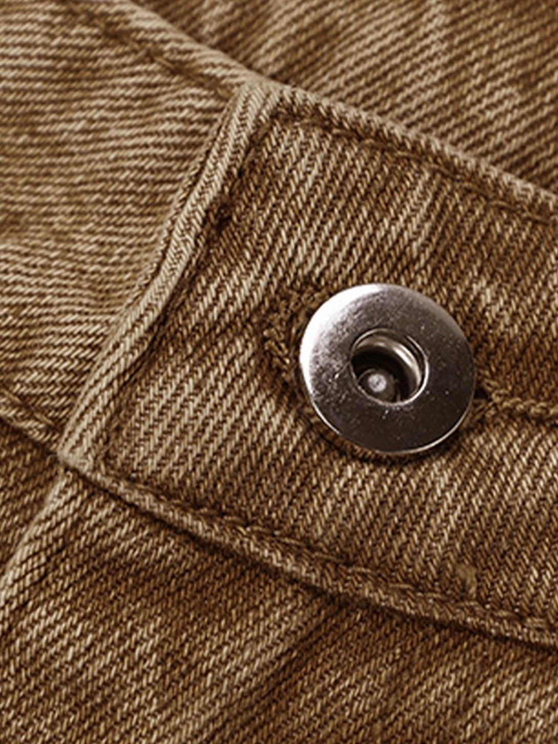 Detailed fabric and stitching of TALISHKO's retro distressed denim shorts, emphasizing texture.